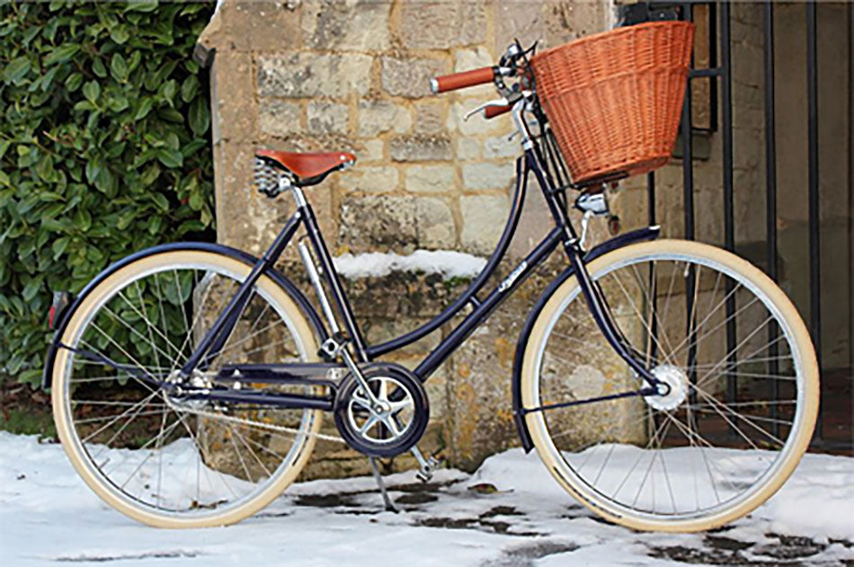 A blue Pashley Britannia bicycle in the snow.