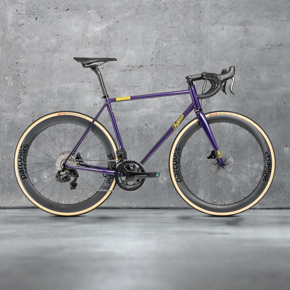 Violet Roadfinder SL road bike with a black saddle and handlebars on a grey background