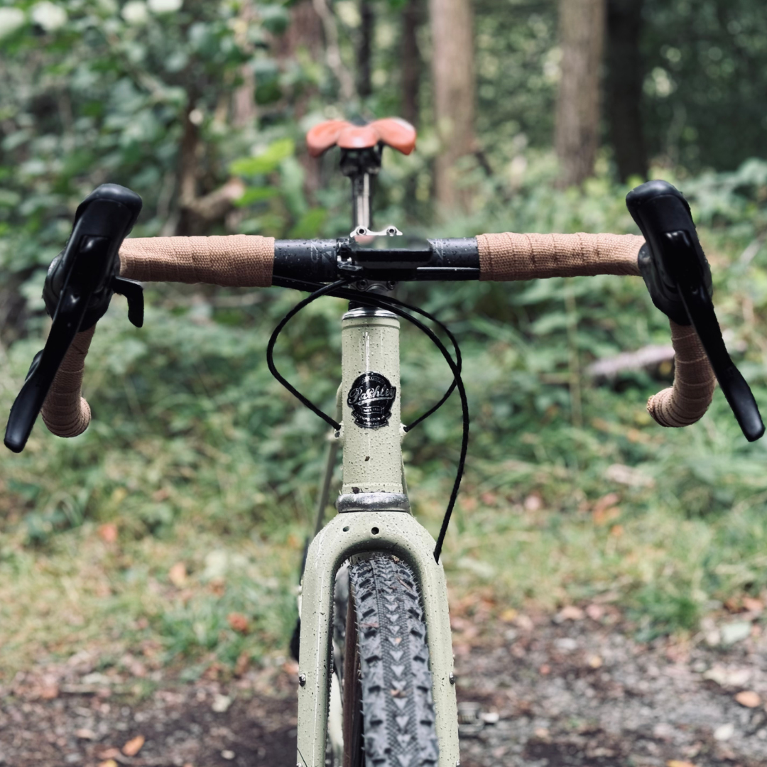Front view of a Pashley Roadfinder X bike showing the drop handlebars and brown leather saddle and Pashley script logo on the black headbadge