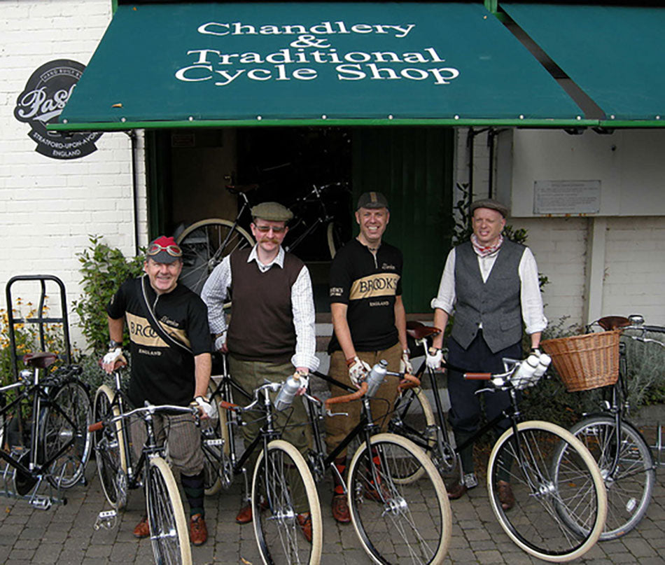 Four gentlemen from the Guv'nor's assembly standing outside the Traditional Cycle Shop with with Guvnor bicycles.