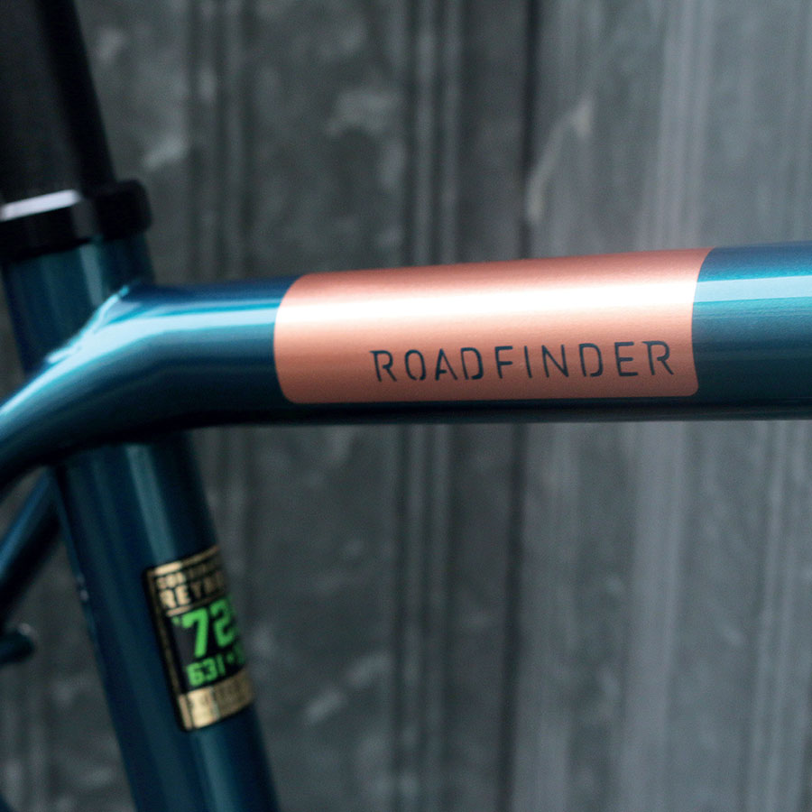 Close up of a bike frame showing the Roadfinder decal on the frame