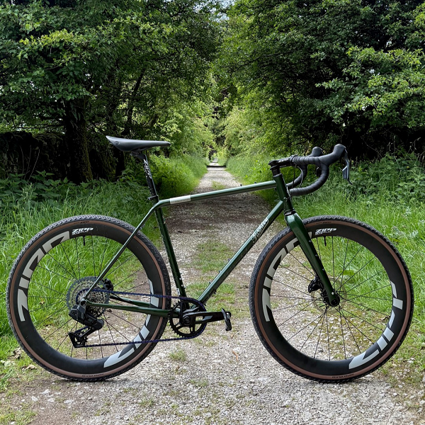 A green Roadfinder X gravel bike on a gravel track