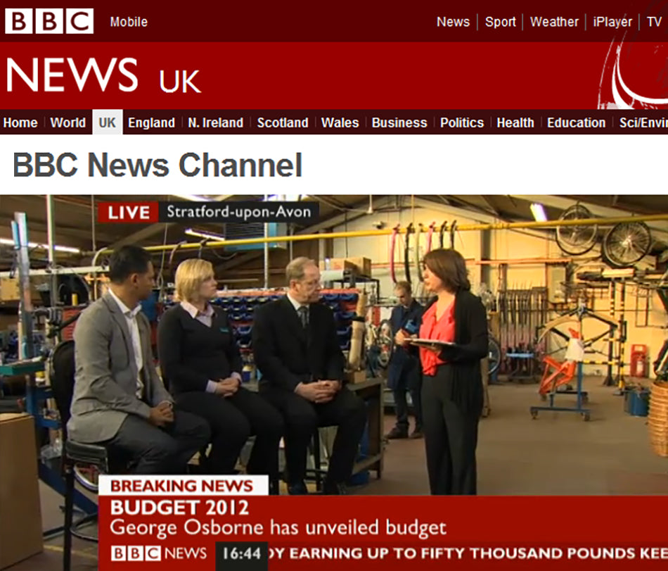 A BBC presenter interviewing people about the 2012 budget inside the Pashley Cycle's factory in Stratford-upon-Avon.