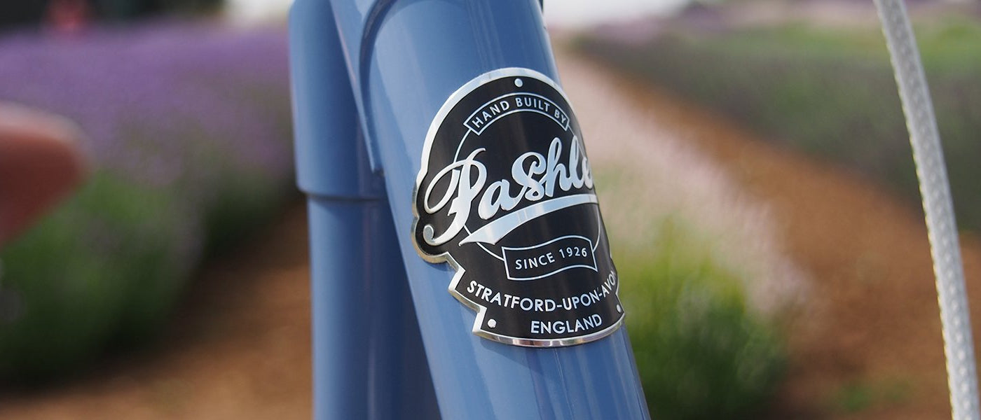 Pashley headbadge of the front of the Pashley Poppy Bicycle in Pastel Blue.