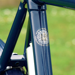 A close-up of the King's Coronation 2023 logo on the frame of the Kingsman bicycle.
