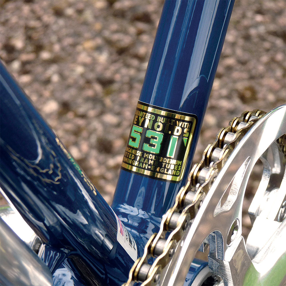 A close-up of a Reynolds 531 steel graphic on the blue frame of the Kingsman bicycle.