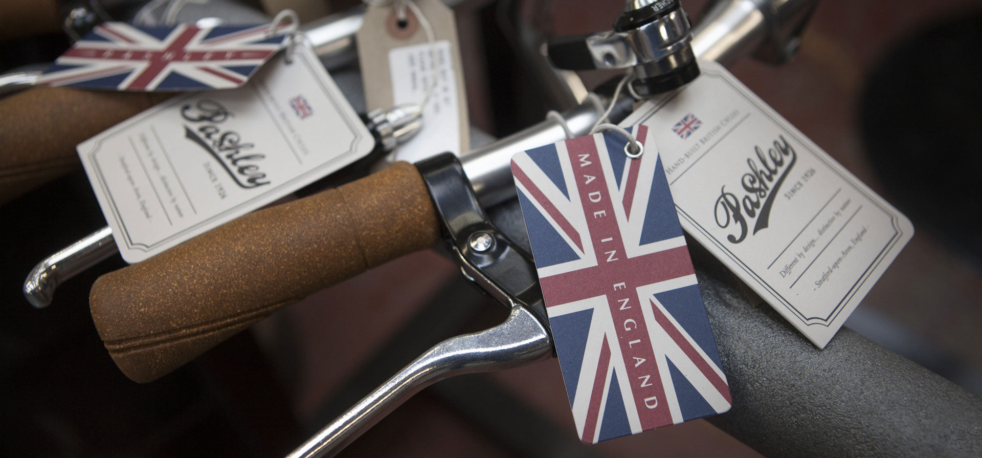 Pashley union jack swing tickets hanging from bicycle handlebars.