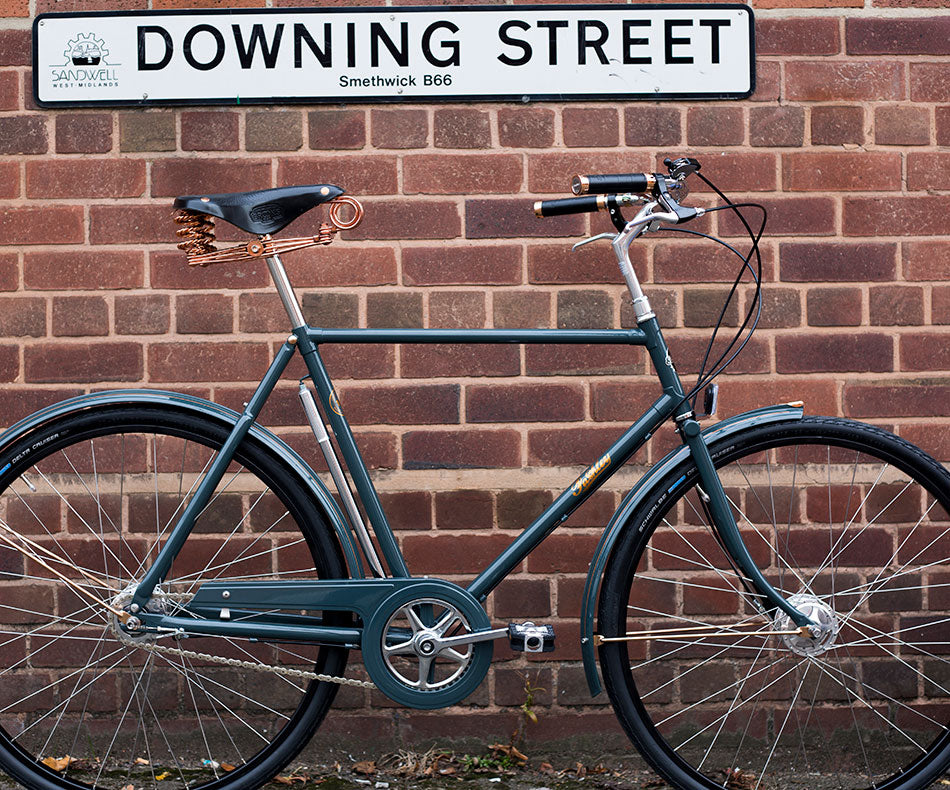 Pashley Brooks Roadster bike with beautiful copper detailing and green-blue paint finish, leaning against the Downing Street sign in Smethwick.