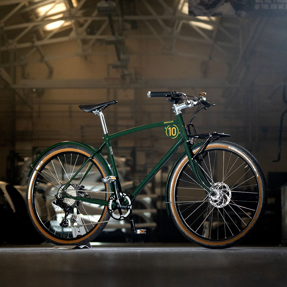 Green classic racing bike on factory floor.