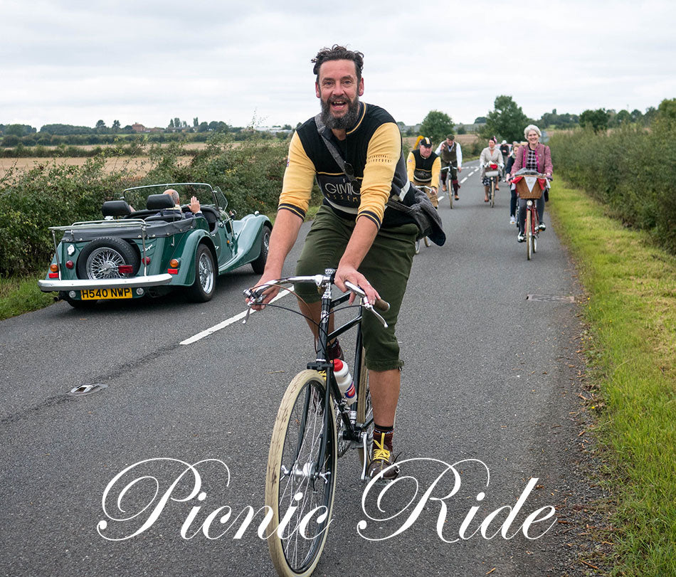 Pashley Guv'nor rider cycling on a Warwickshire countryside road whilst a vintage Morgan car drives by.