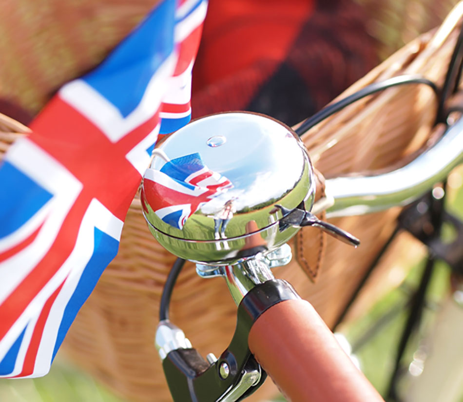 Pashley silver chrome ding-dong bell next to a union jack flag.
