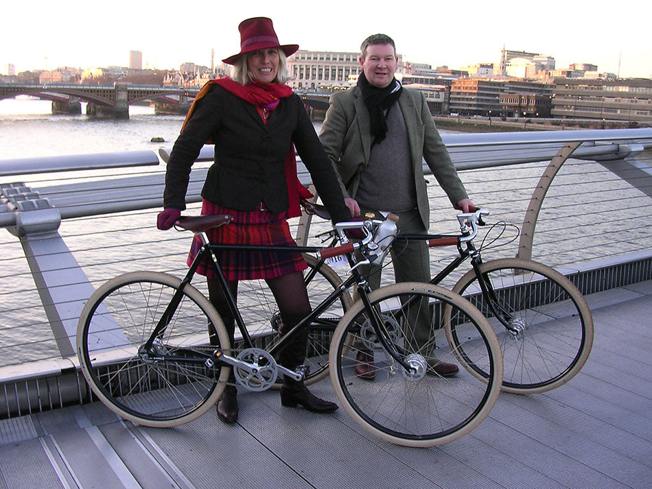 Lady and gentlemen dressed in tweed standing with their Pashley Guv'nor bicycles.