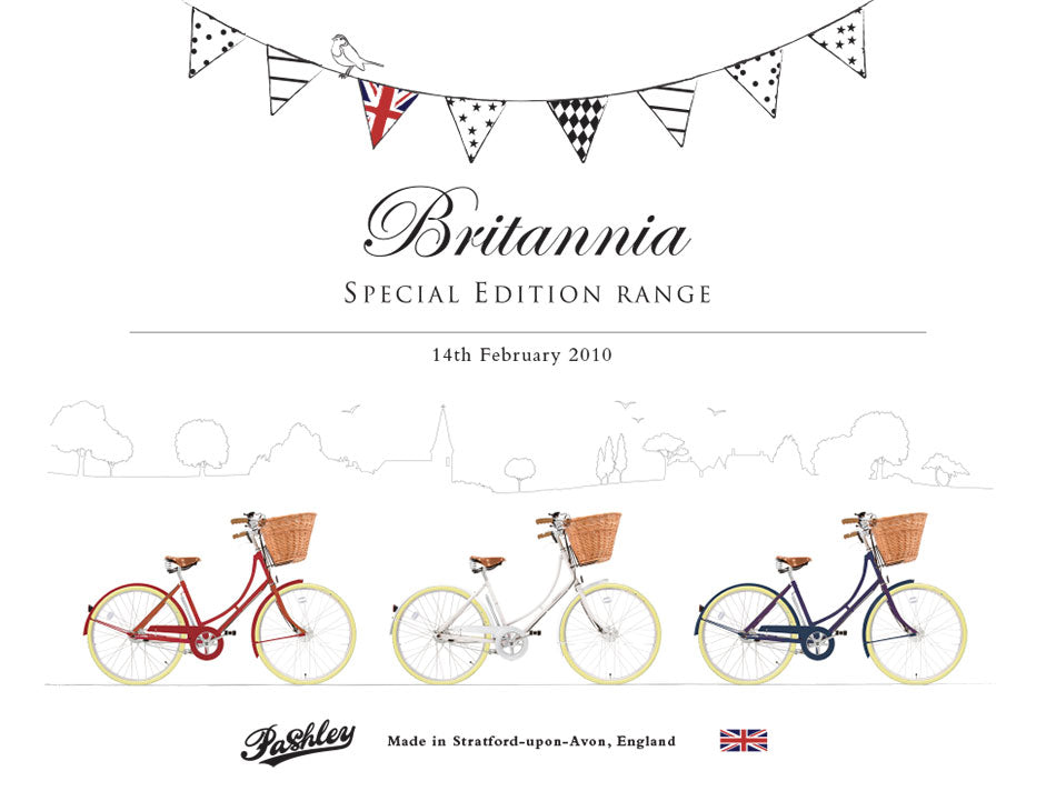 Three classic Britannia bicycles- red, white and blue - with countryside illustration and black and white bunting in the background.