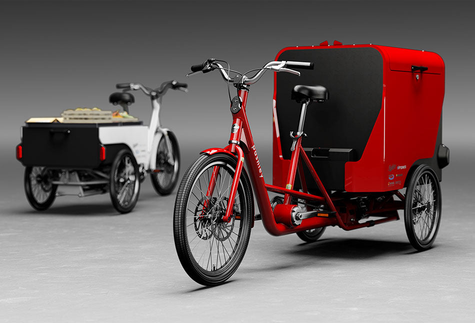 3D computer rendering of Pashley e-cargo electric trikes showing one in red with large cargo box and one in white with a pick-up style cargo bed.