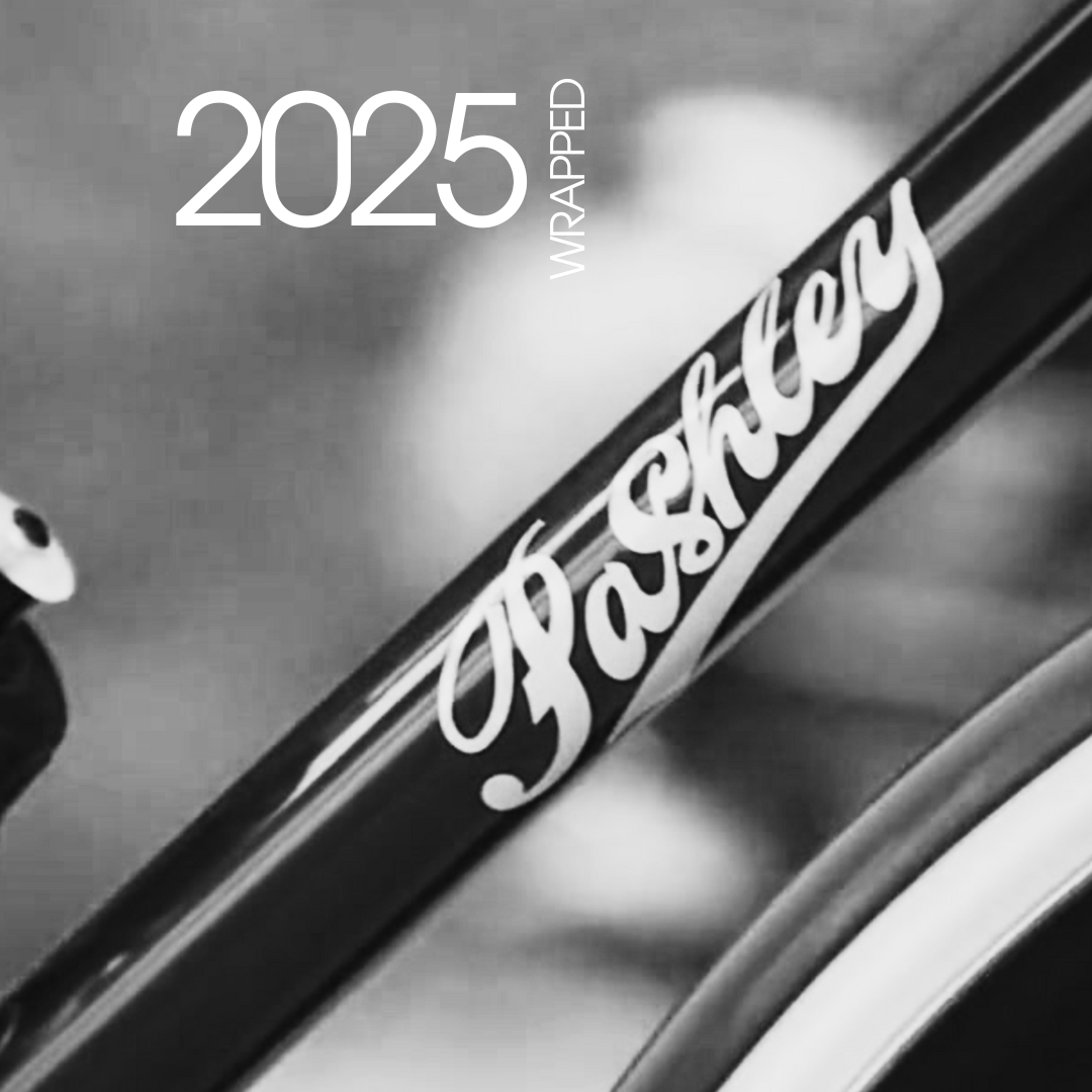 Black and white image showing a close up of the Pashley script logo on a bicycle frame