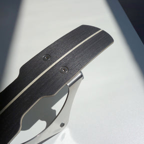 Close-up of black wooden bicycle mudguard with centre pin stripe and stainless brackets.