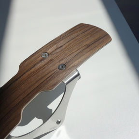 Close-up of a walnut wooden mudguard with stainless brackets.