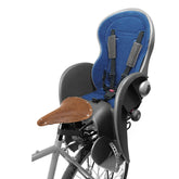 A grey and blue bicycle child seat attached to a rear pannier rack.